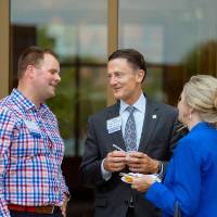 A group of three in a conversation.